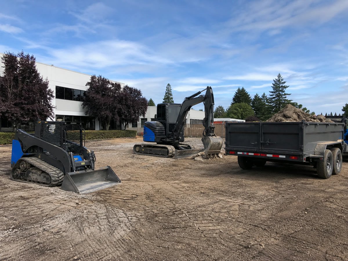 Organized light commercial site with a prepared pad and loaded trailer