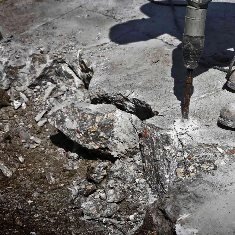 Concrete driveway being broken out and loaded on a compact San Pablo residential lot
