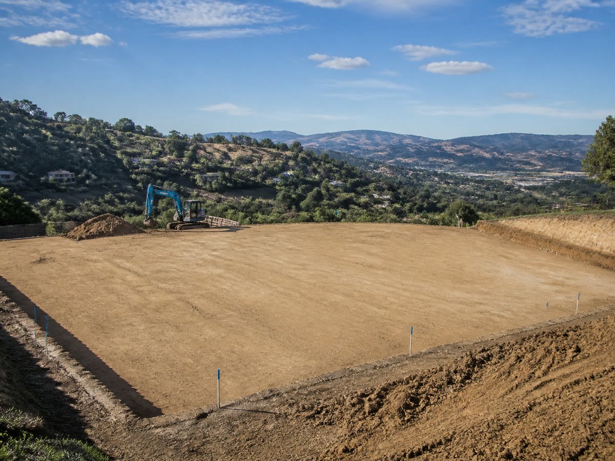 Perfectly level building pad marked with grade stakes