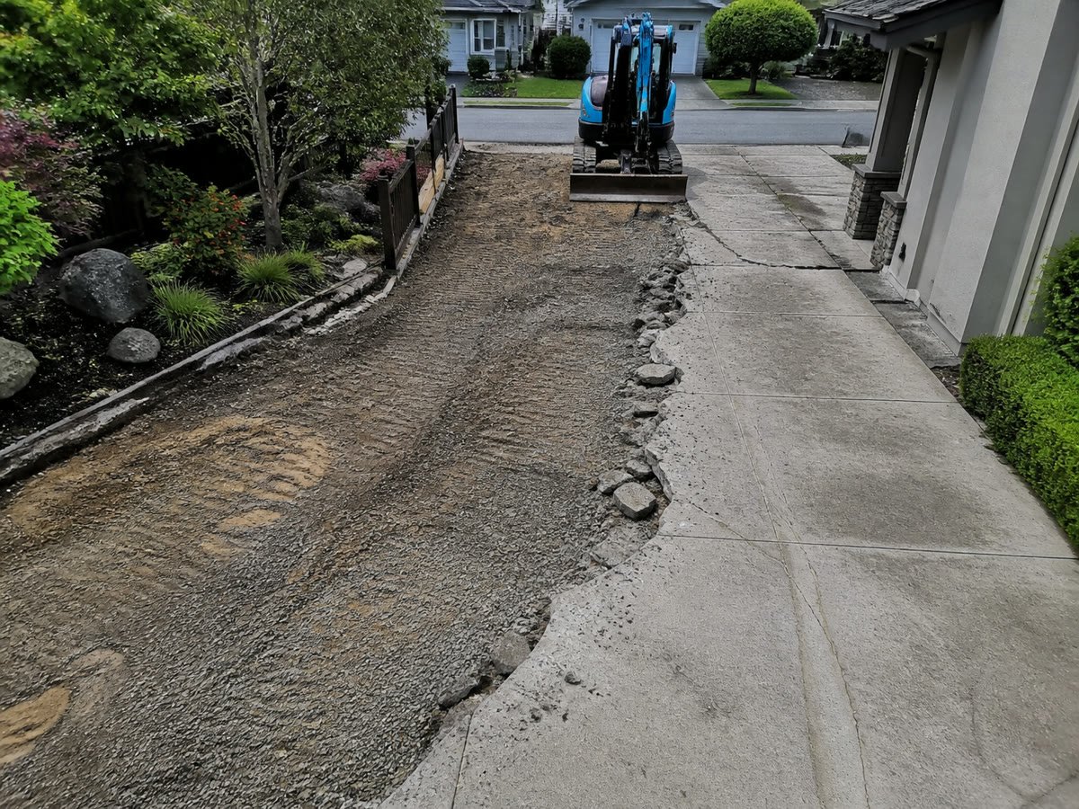 Driveway halfway removed with the aggregate subbase exposed