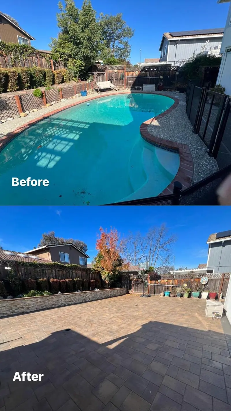 Excavator breaking out the gunite shell of a swimming pool during a full pool removal