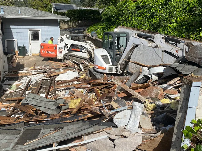 Structure demolition with debris sorted for haul-off